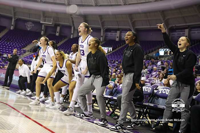 TCU's bench, including starters (left to right) Madison Conner (3), Jaden Owens (1), and Sedona Prince (13), celebrates a made shot against Omaha.